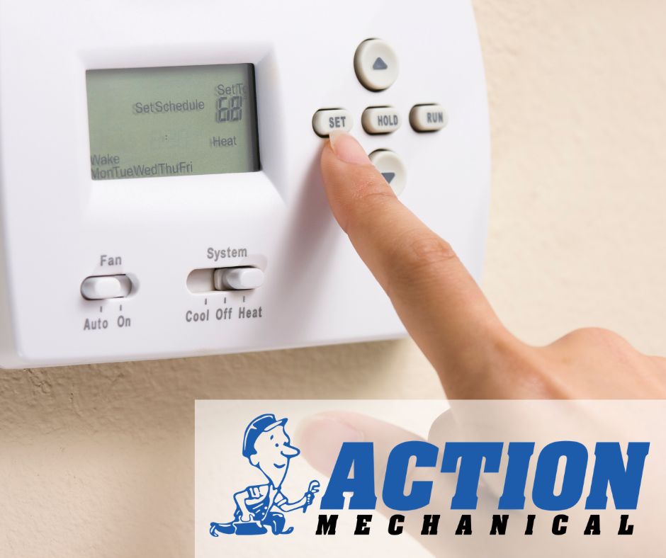 Picture of someone changing a thermostat's settings.